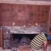 We also found buried in the wall the Greenes' orignial Grueby tile fireplace!  It, too, was covered in 1918 remodel.  We were eager to restore it, but holes had been punched in corners of some tiles to secure a new Tudor mantle. 