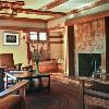 Serene view of restored living room, courtesy of photographer Alex Vertikoff, shows original features we reproduced based on a tiny pre-1918 photo.   Small casements (found in the basement) above new bench, box beams, and trim were all installed by master craftsman Glen Stewart. 