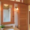 New second floor bath is tiny but bright with borrowed light from stairwell skylights.  White tile walls are framed in Douglas fir trim.  Console top and floor are limestone.