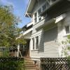 Back view of house was taken before renovation.  Small service porch blocked view of gardens, and unused driveway ate up valuable space. 