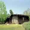 Roofs of guest house and garage are the same slope and repeat, appearing to telescope from one another.