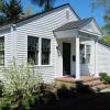 Details are crisp and clear with house painted all white.  "Carriage house doors" are beadboard, opening outward on strap hinges.  Porch is of handmade brick. 