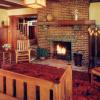 Restored living room shows original brick fireplace and redwood wainscot.  Stair beyond is in entry.