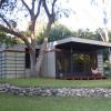 View from southwest shows sycamore tree in corner of addition. Cantilevered roof provides a shaded terrace in hot summer months. 