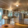 Kitchen has open shelving with glass cabinets for dishes and pantry.  Owner's folk art and ceramics can easily fit it.